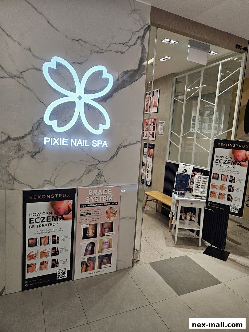 The entrance of Pixie Nail Spa, featuring its logo and promotional posters.