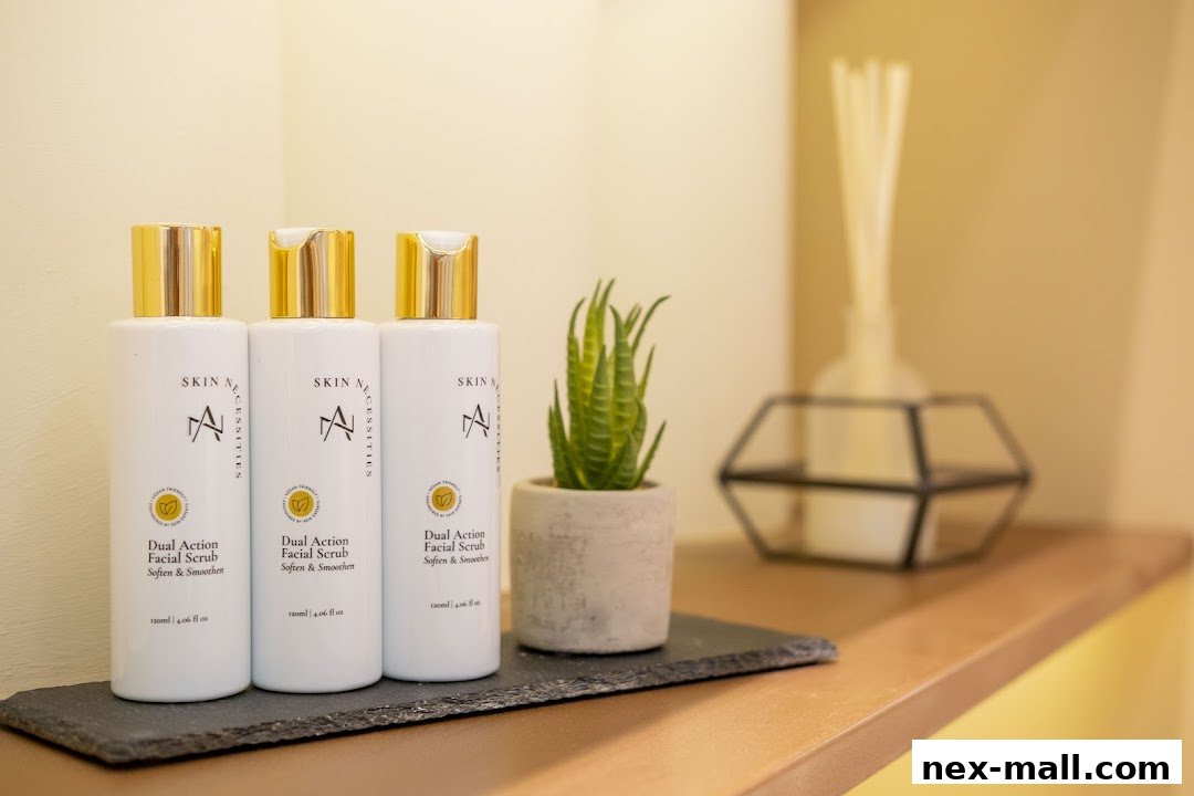 Three bottles of 'Dual Action Facial Scrub' from Skin Necessities are displayed on a shelf.