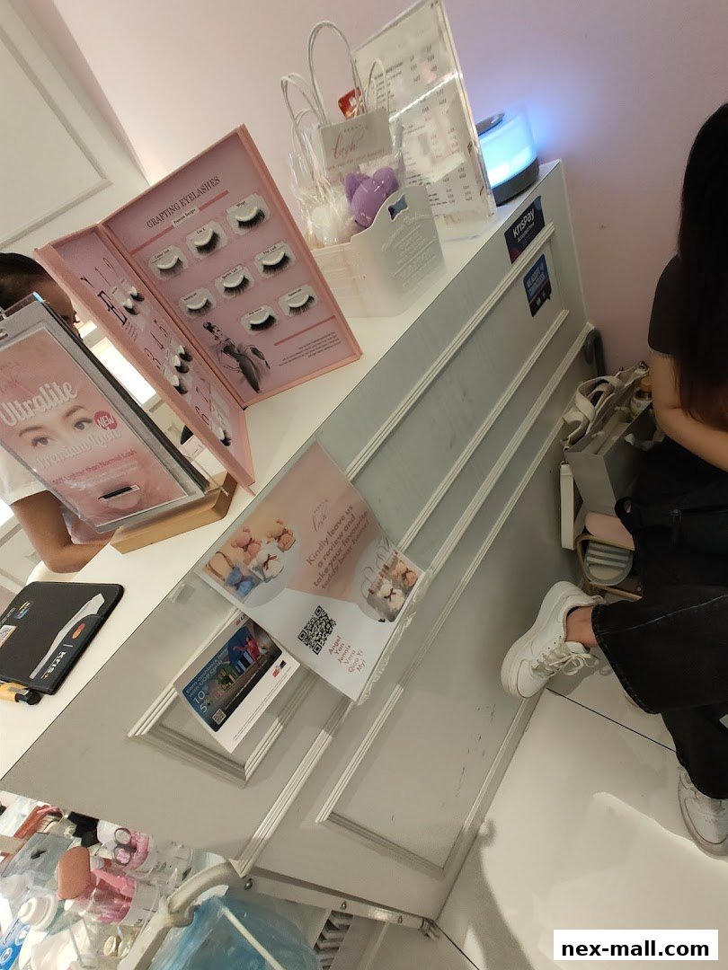 A display of eyelash extensions and promotional materials at a beauty salon.