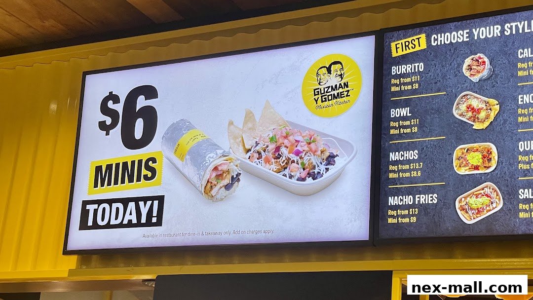 A digital menu board for Guzman y Gomez, showcasing Mexican food options and prices.
