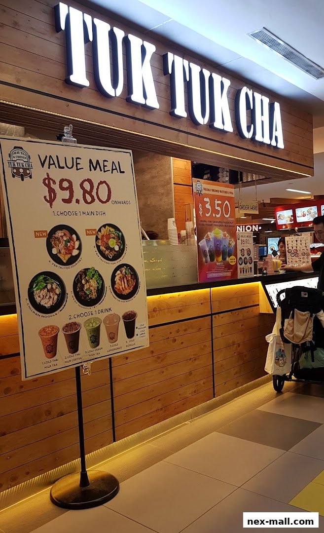 A sign displays a value meal deal for $9.80 at Tuk Tuk Cha, featuring various Thai dishes and drinks.