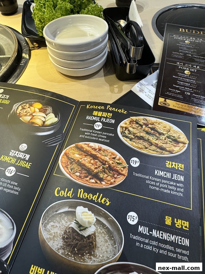 A menu featuring Korean dishes like pork sets, kimchi jjigae, and cold noodles.