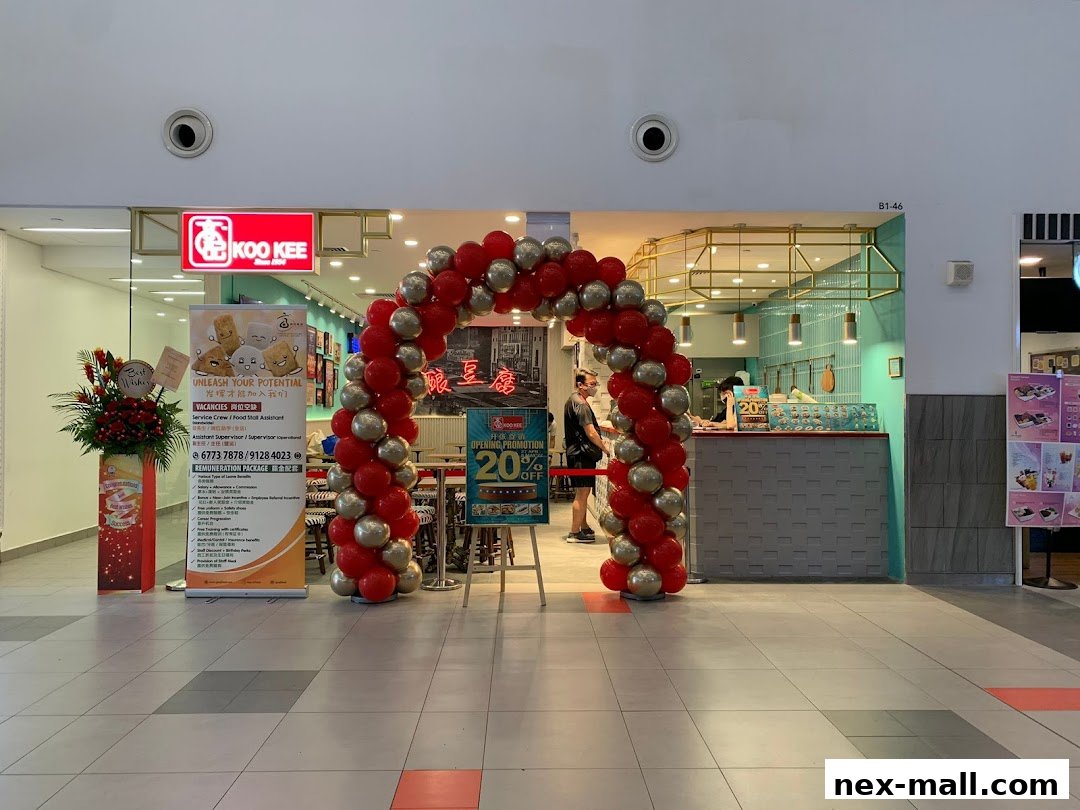 Koo Kee shop entrance decorated with red and silver balloons, featuring a promotion banner.