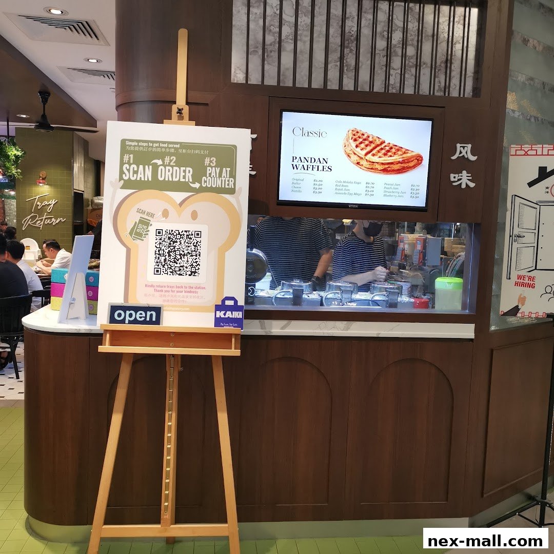 A sign with ordering instructions and a menu display for Pandan Waffles at The Hainan Story Coffee House.