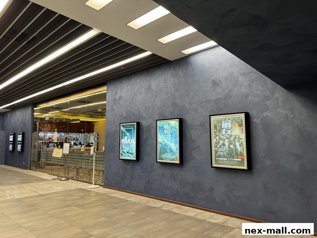 The entrance to Shaw Theatres NEX, featuring movie posters and a ticket counter.