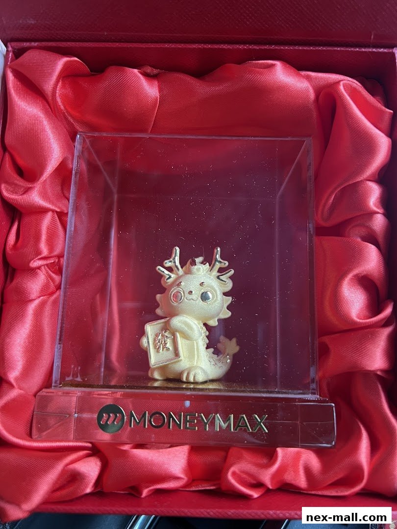 A golden dragon figurine in a red gift box with MoneyMax branding.