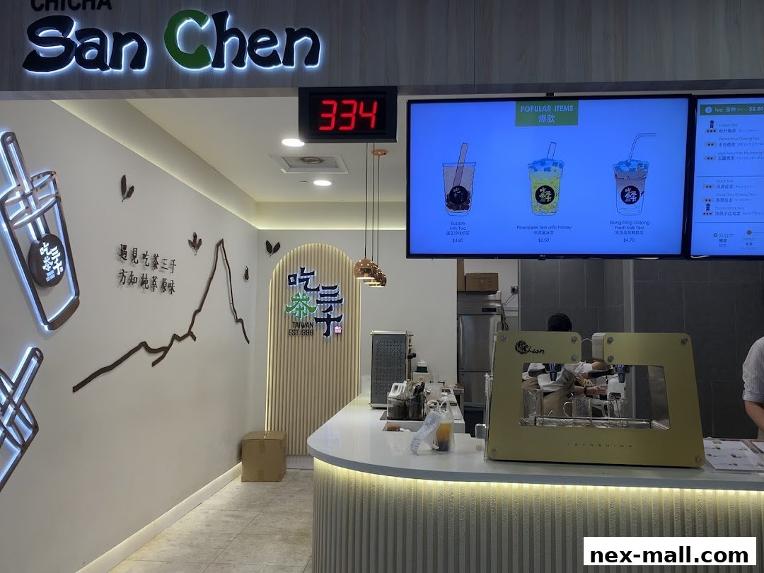 Interior view of a CHICHA San Chen bubble tea shop with a digital display and menu board.