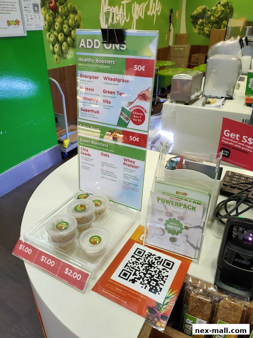 A Boost Juice counter displaying add-on boosters, QR codes, and products.