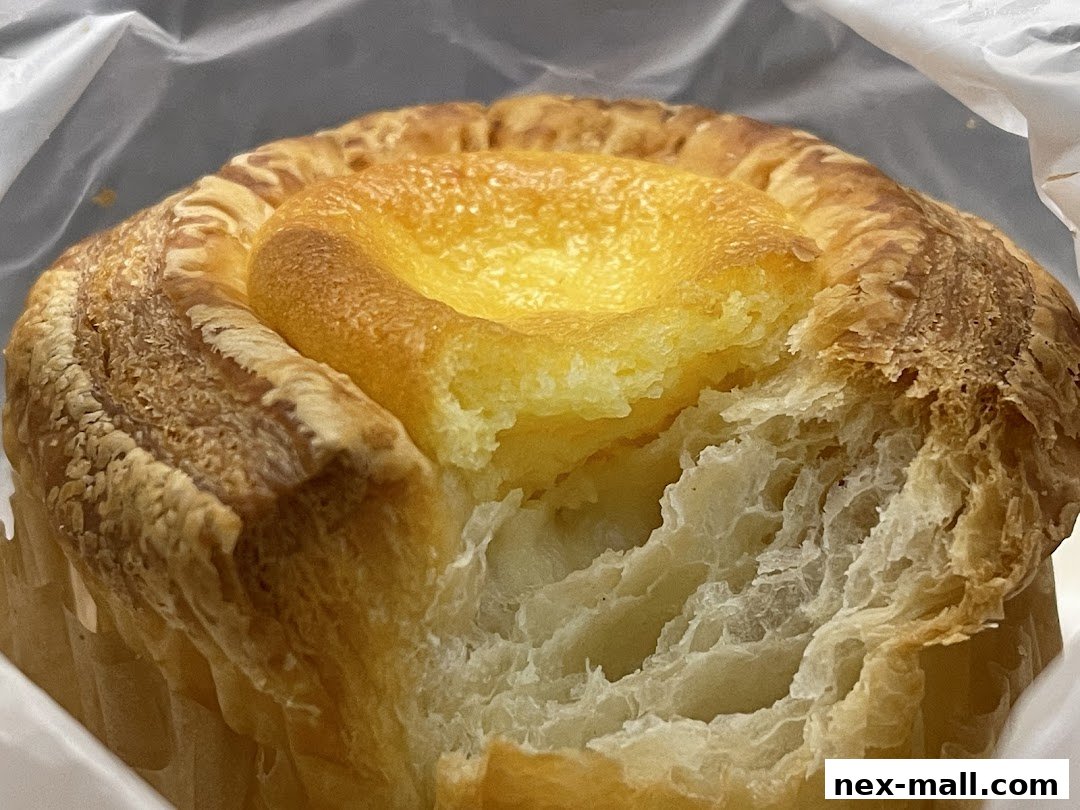 A close-up of a delicious Japanese cheese bread with a flaky crust and soft interior.