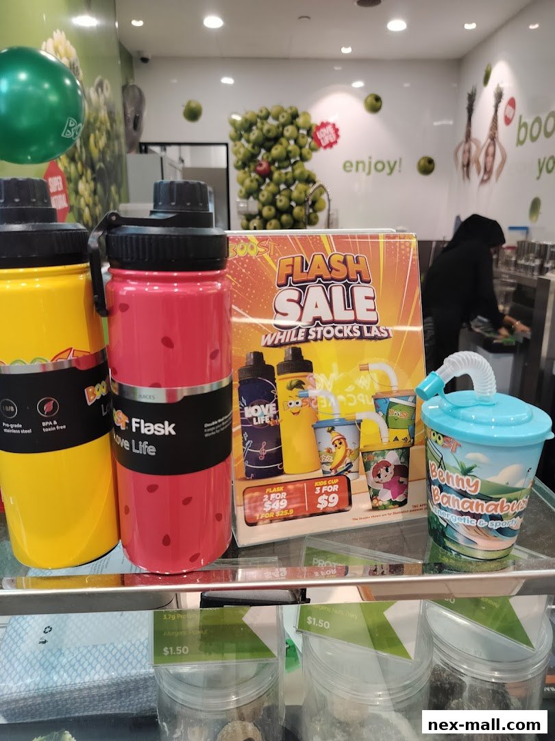 Boost Juice NEX shop interior with promotional items and drinks on display.