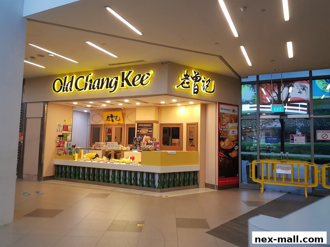 The Old Chang Kee shop front with its signature yellow signage and display of food items.