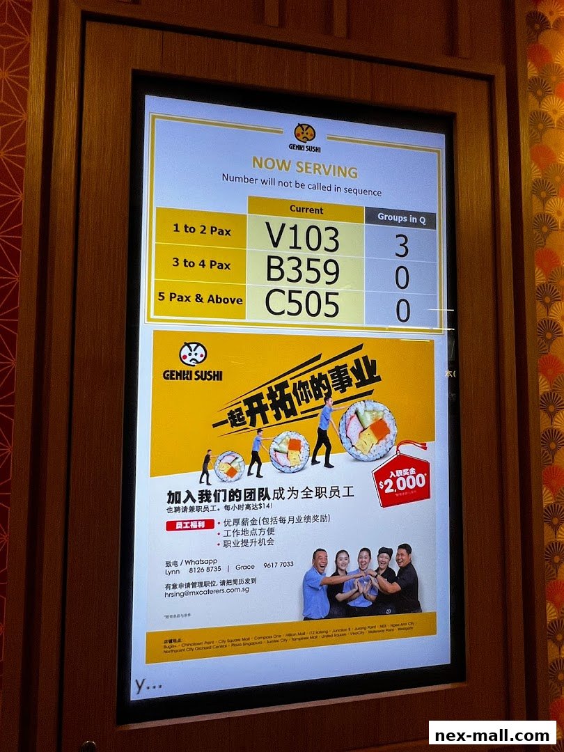 A digital display showing current waiting numbers and a recruitment advertisement for Genki Sushi.