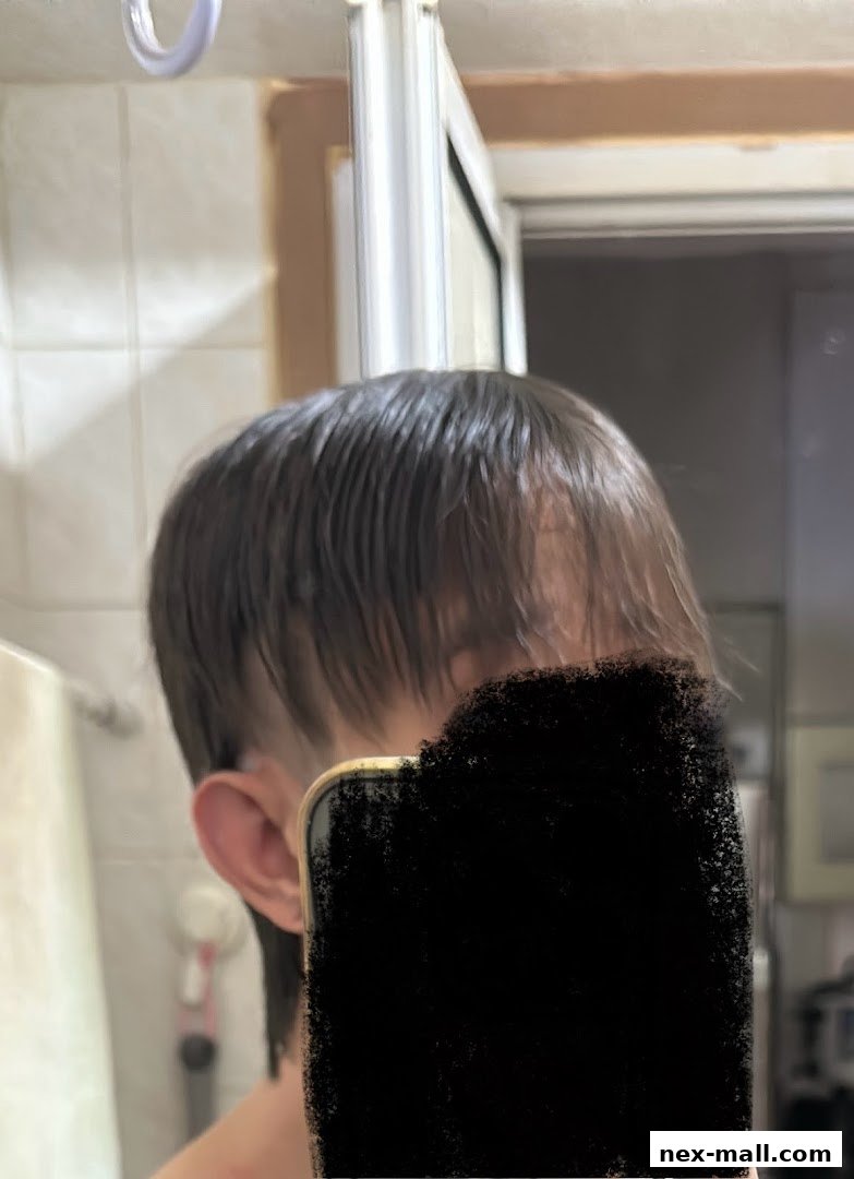A person's head and ear are visible, with wet hair and a blurred face.