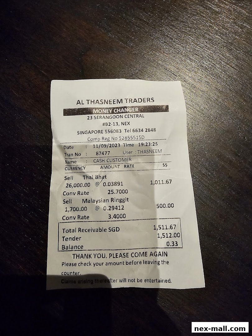 A receipt from AL Thasneem Traders Money Changer detailing currency exchange transactions.