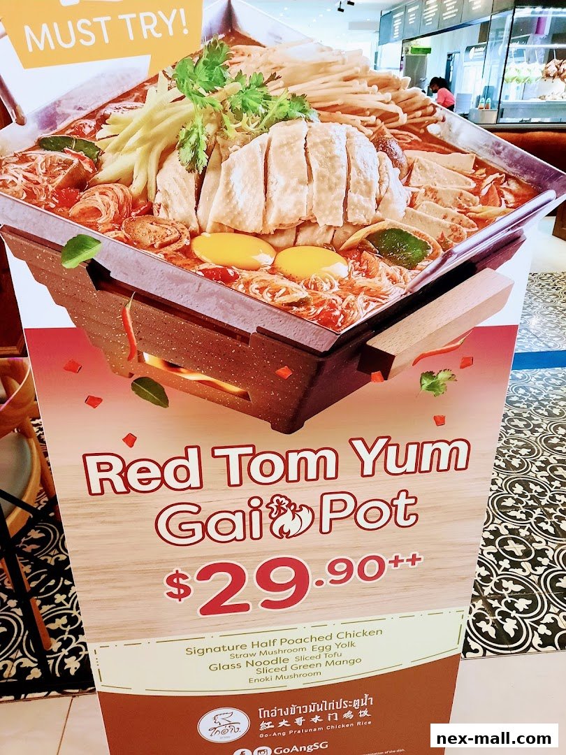 A promotional sign for Go-Ang Pratunam Chicken Rice's Red Tom Yum Gai Pot.