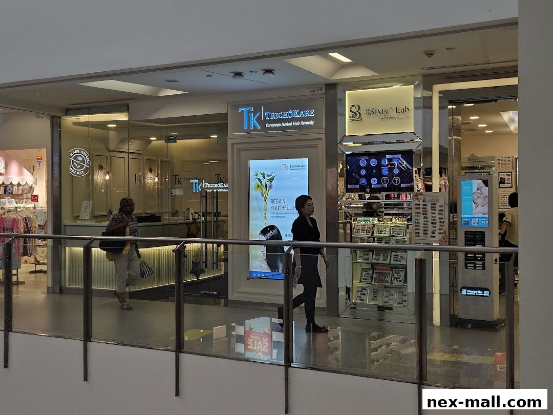 The exterior of TK TrichoKare and 3Sixty Lab shops in a mall, with people walking by.