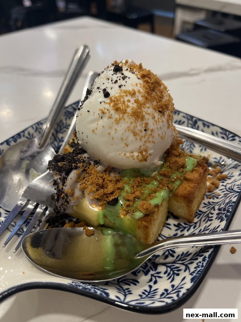 A delicious dessert with ice cream, sauce, and crumbs on a decorative plate.