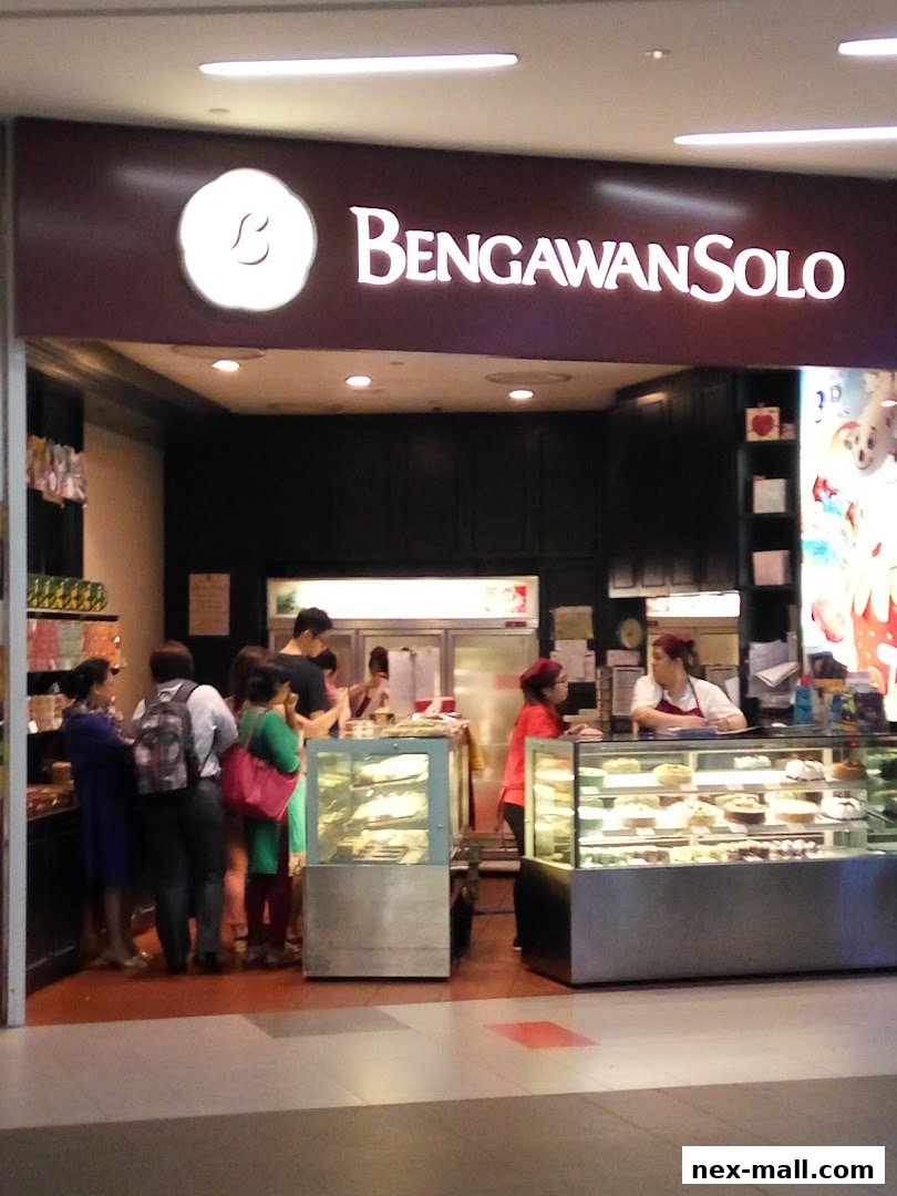 Customers queue at Bengawan Solo, a shop displaying cakes and pastries in display cases.