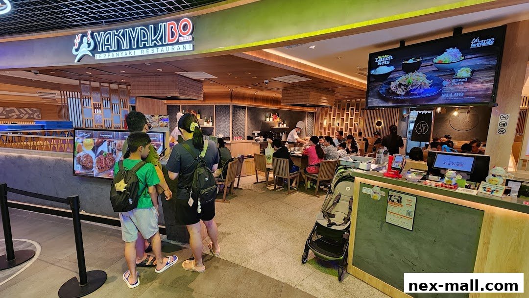 The entrance and interior of Yaki Yaki Bo Teppanyaki Restaurant with customers dining.