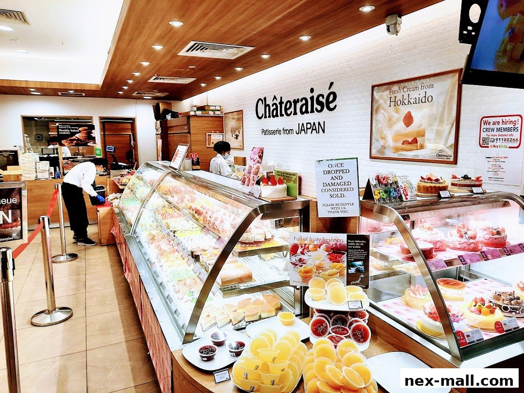 Interior of a Châteraisé patisserie shop showcasing a display of cakes and pastries.