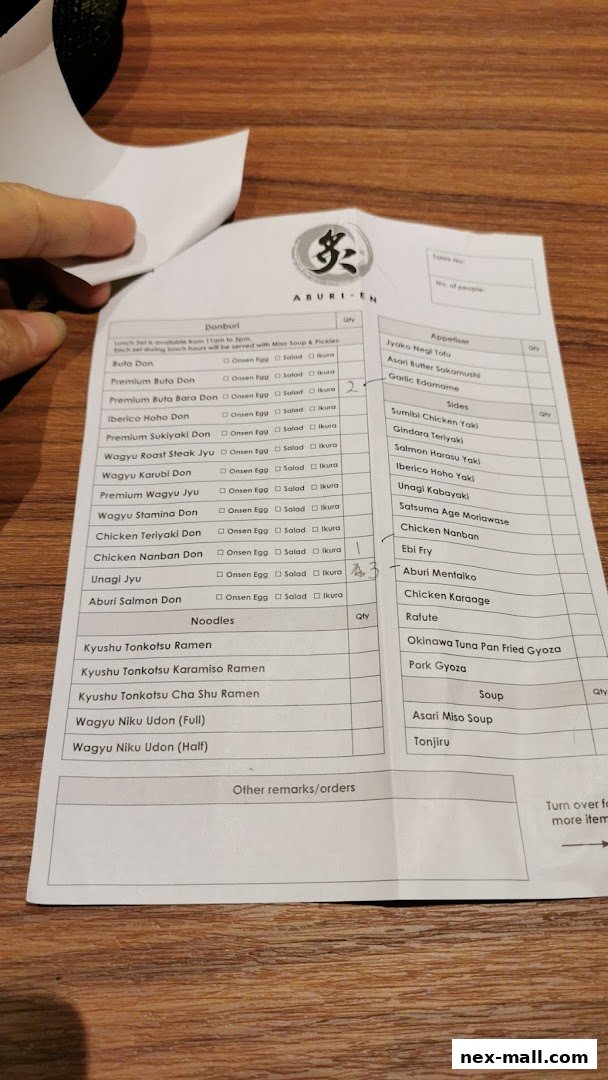 A close-up of a Japanese restaurant's order form with various dishes listed.