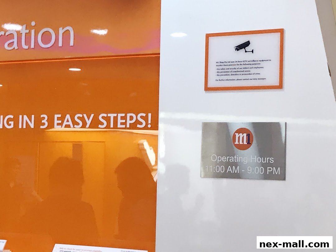A shop interior with orange branding and signs indicating operating hours and CCTV surveillance.