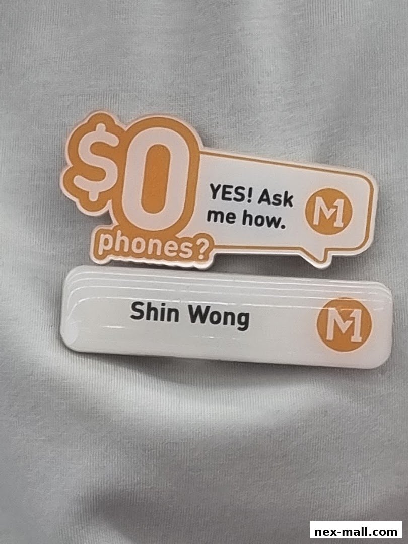 A promotional badge for a phone shop offering $0 phones, with a name tag for Shin Wong.