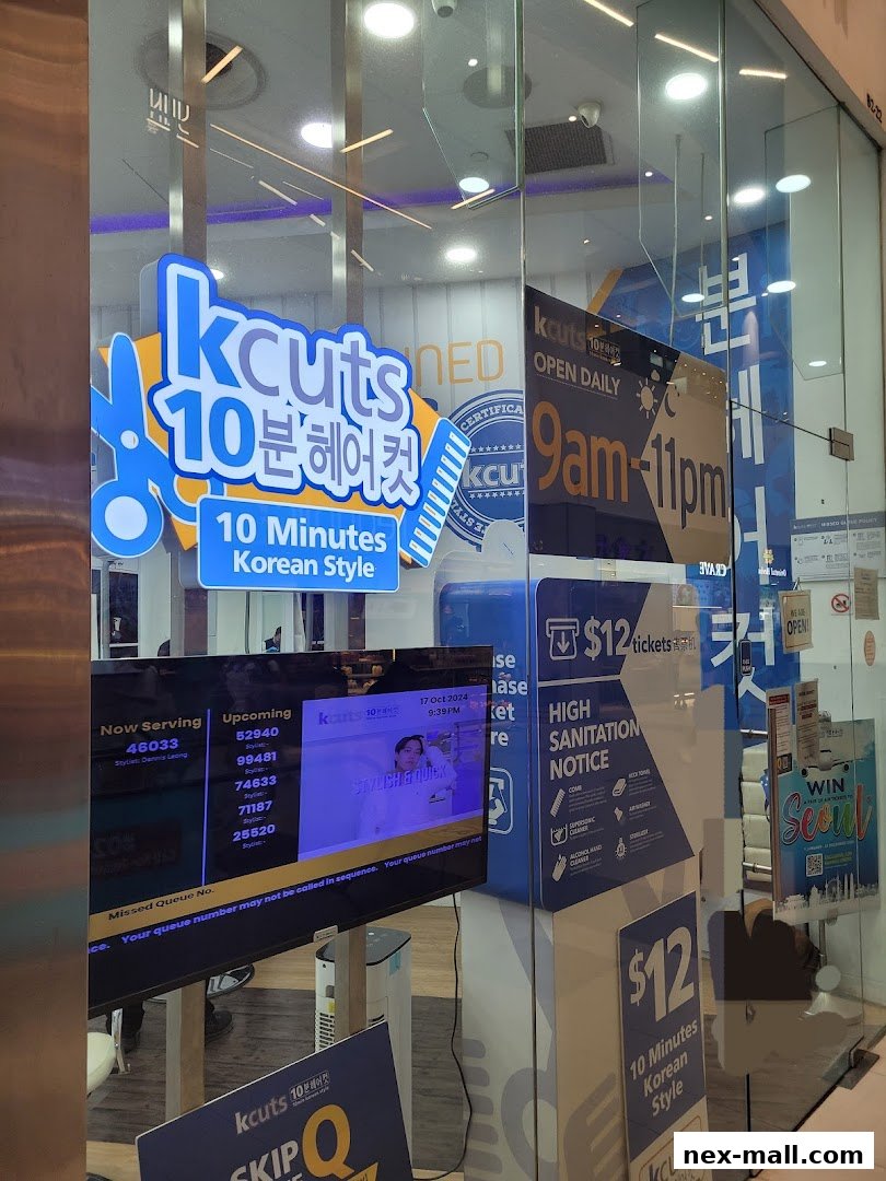 The storefront of Kcuts, a hair salon offering 10-minute Korean style haircuts, with operating hours and queue information displayed.