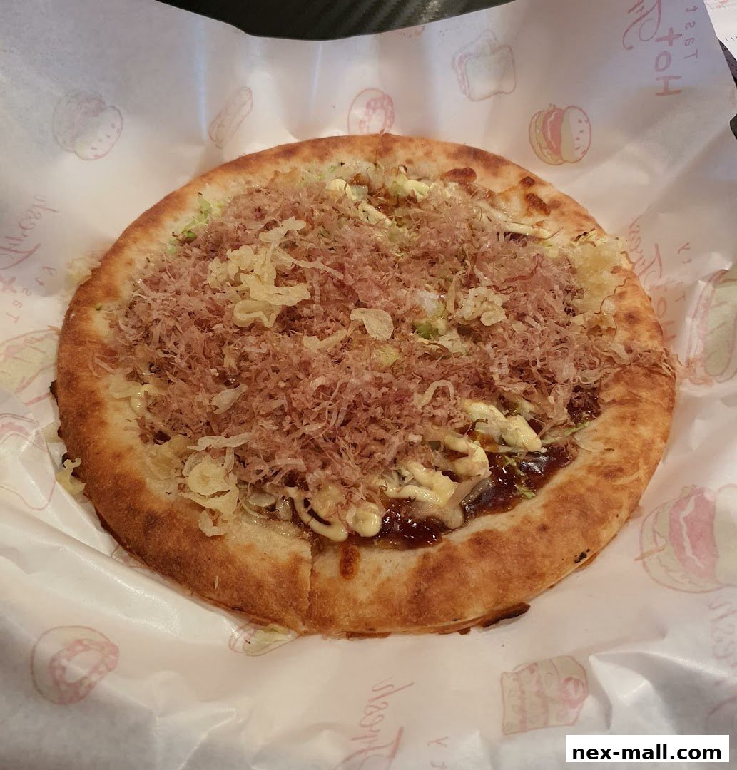 A close-up of a delicious okonomiyaki dish from Monster Curry.