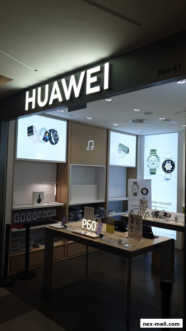 The Huawei Concept Store NEX features illuminated displays showcasing smartwatches and phones.