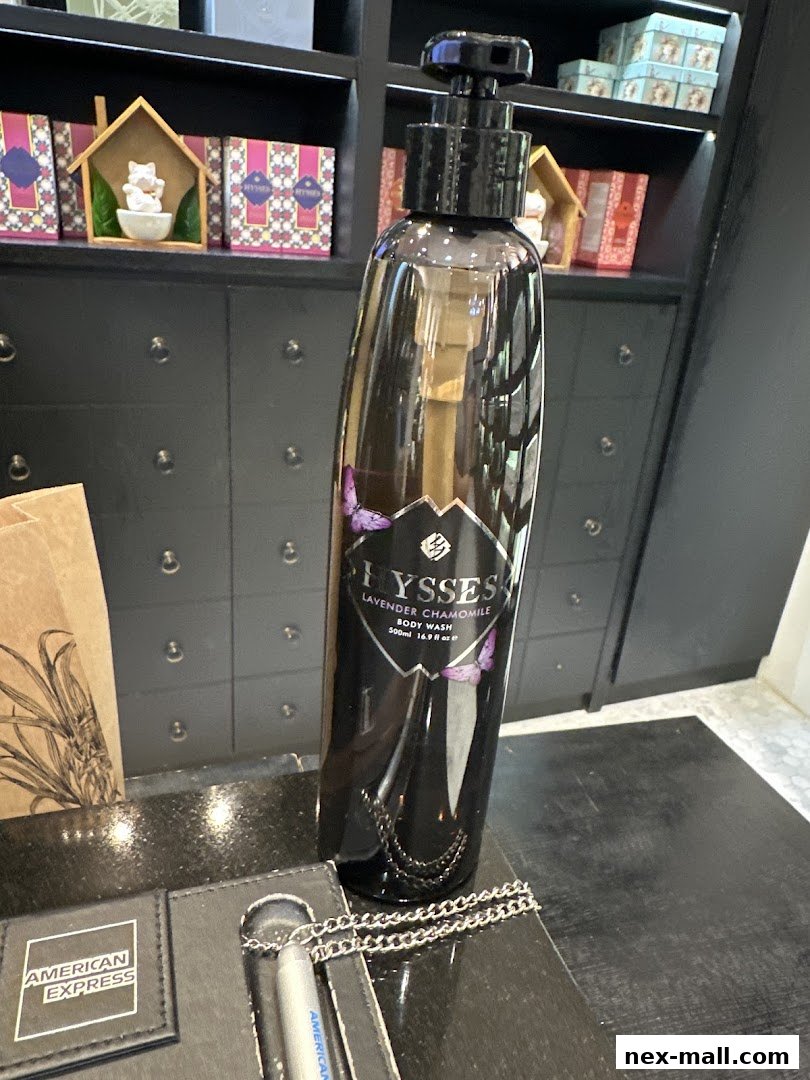 A bottle of HYSSES Lavender Chamomile Body Wash displayed on a counter with American Express branding.