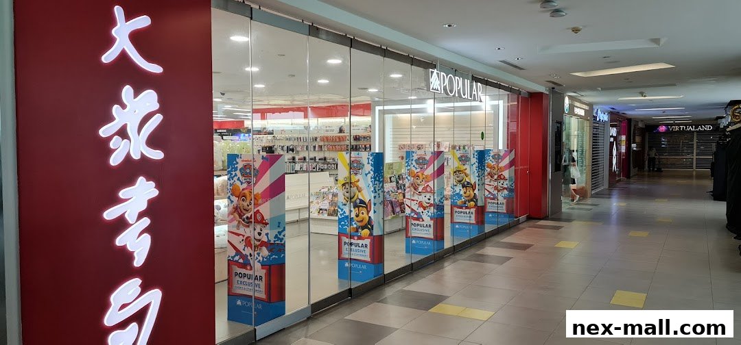 The exterior of a POPULAR Bookstore with large glass windows and Paw Patrol promotional displays.