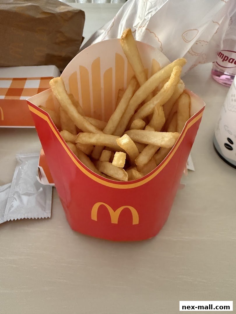 A close-up shot of a red McDonald's carton filled with golden french fries.