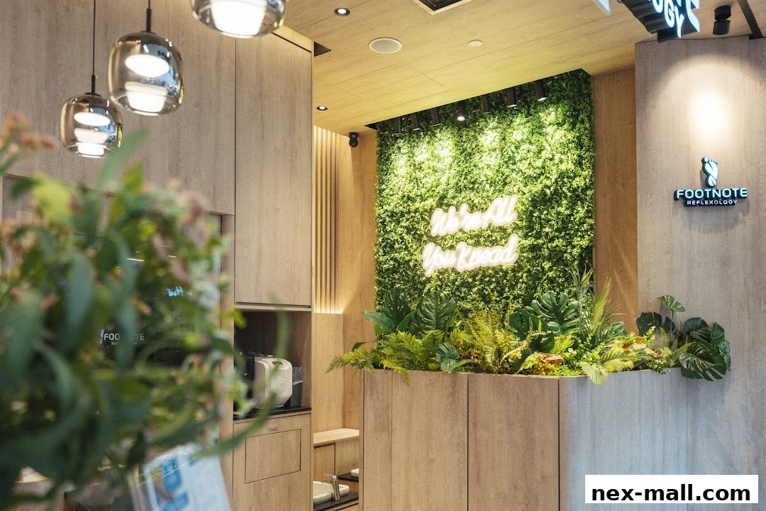 Interior of a reflexology shop with a green wall, neon sign, and modern wooden decor.