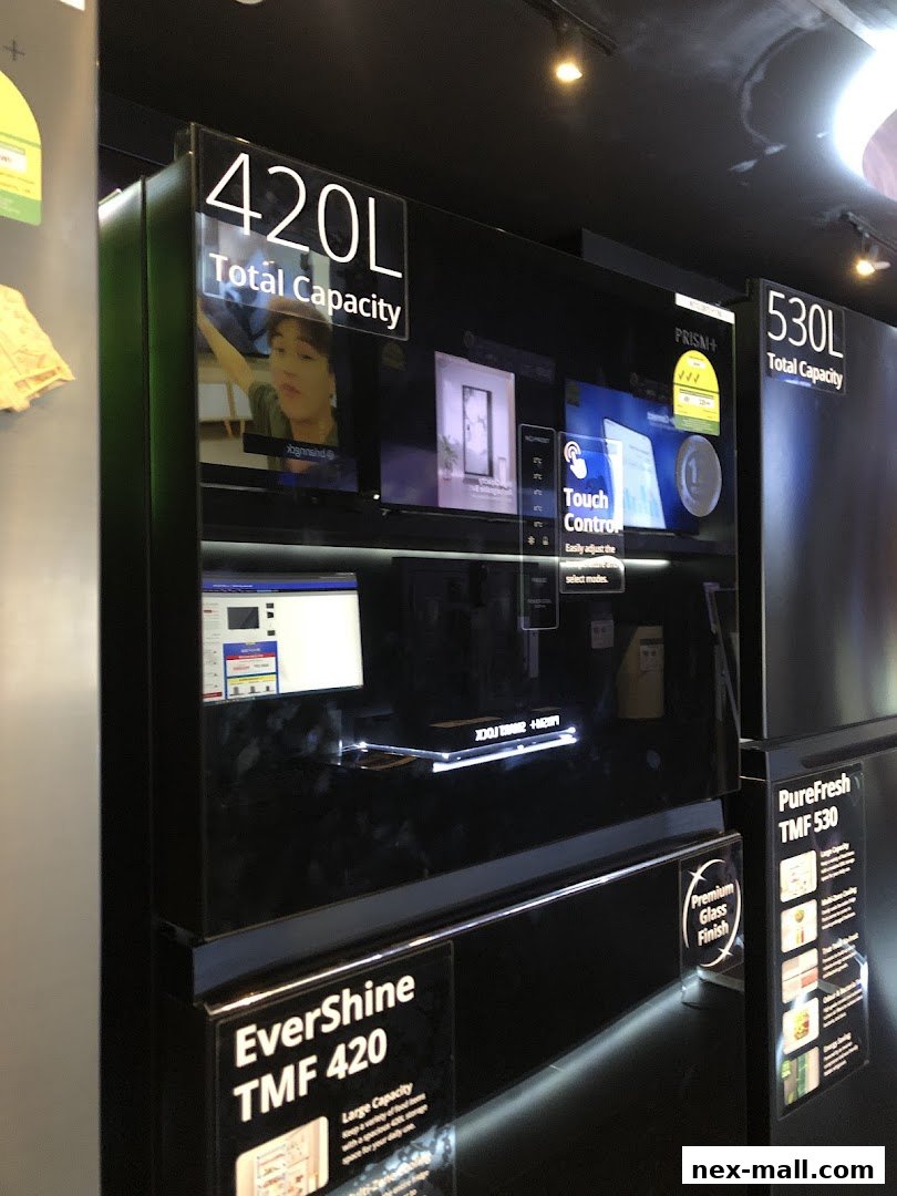 Display of modern refrigerators with touch controls and capacity information.