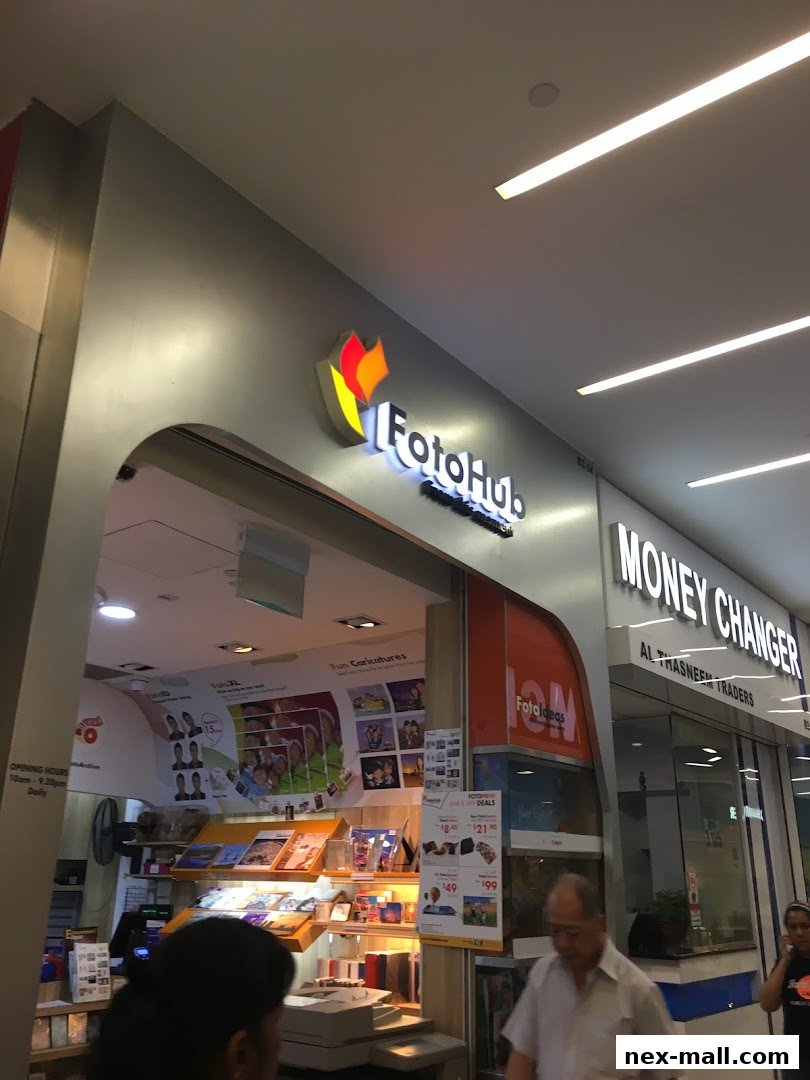 The FotoHub shop front displays its logo, services like 'Fun Caricatures', and various photo-related products.