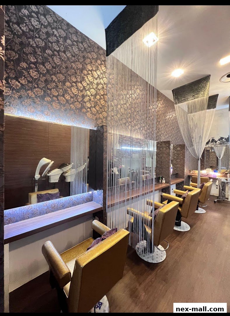Interior of a modern salon with stylish chairs, decorative wallpaper, and unique ceiling features.