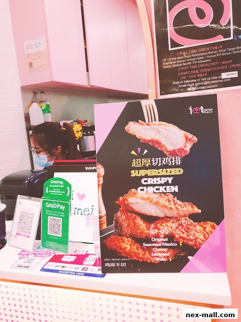 A sign advertising supersized crispy chicken with various flavors and payment options.