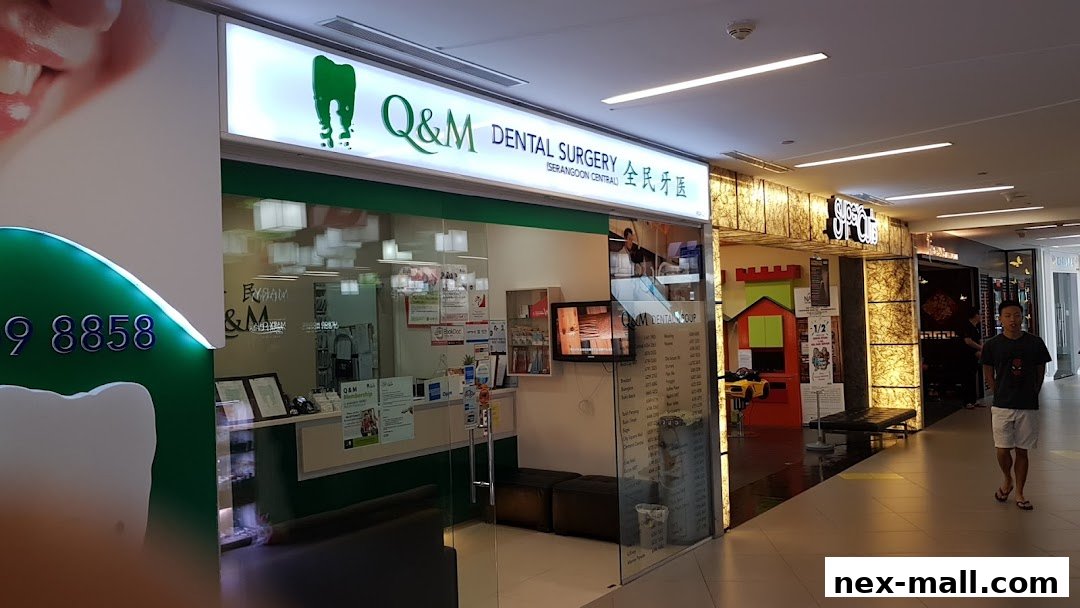 The exterior of Q&M Dental Surgery Serangoon, a modern dental clinic with a bright sign and glass entrance.