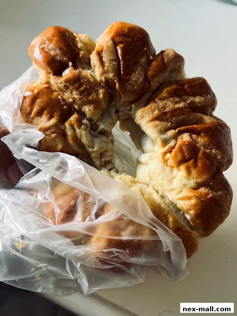A close-up shot of a freshly baked, golden-brown pastry in a plastic bag.