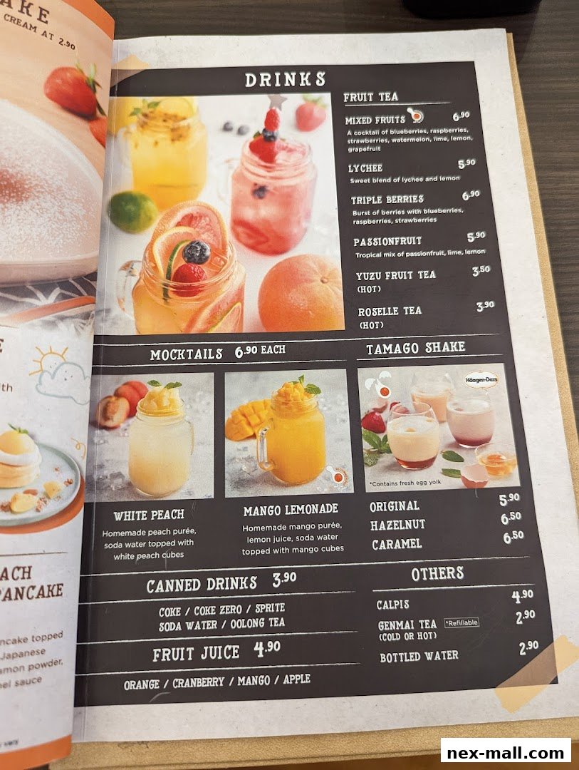 A menu page displaying various drinks including fruit teas, mocktails, canned drinks, and shakes.
