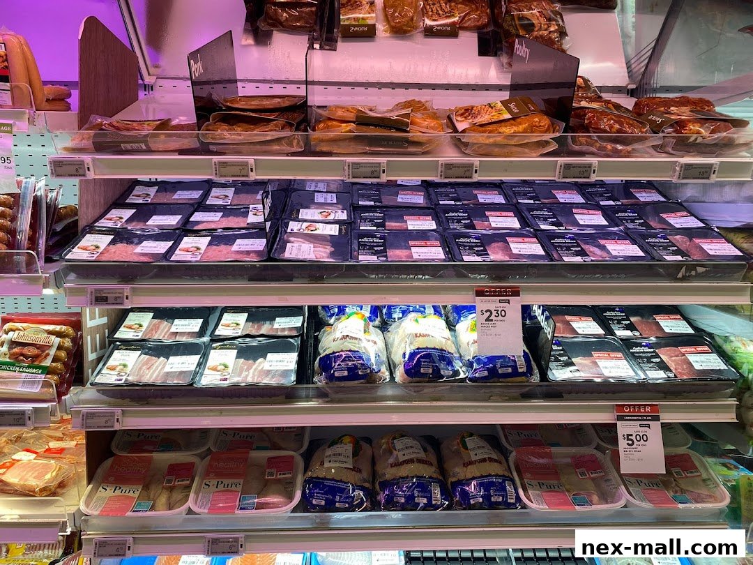 A display of various packaged meats and poultry in a refrigerated section of a grocery store.
