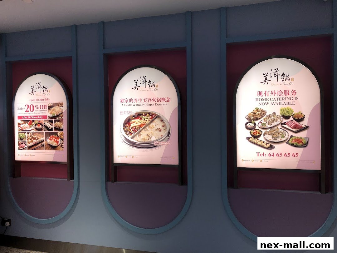 Three illuminated signs for Beauty in The Pot restaurant, showcasing food and promotions.
