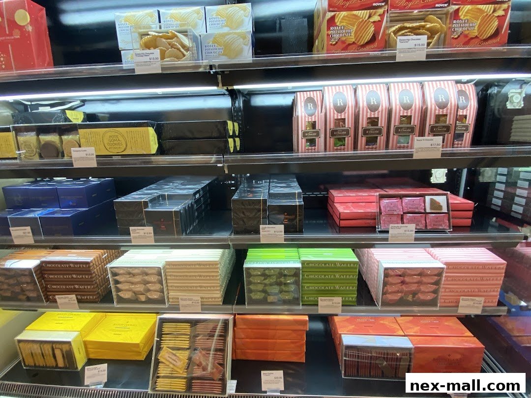 A display of various Royce chocolate and cookie products neatly arranged on shelves.