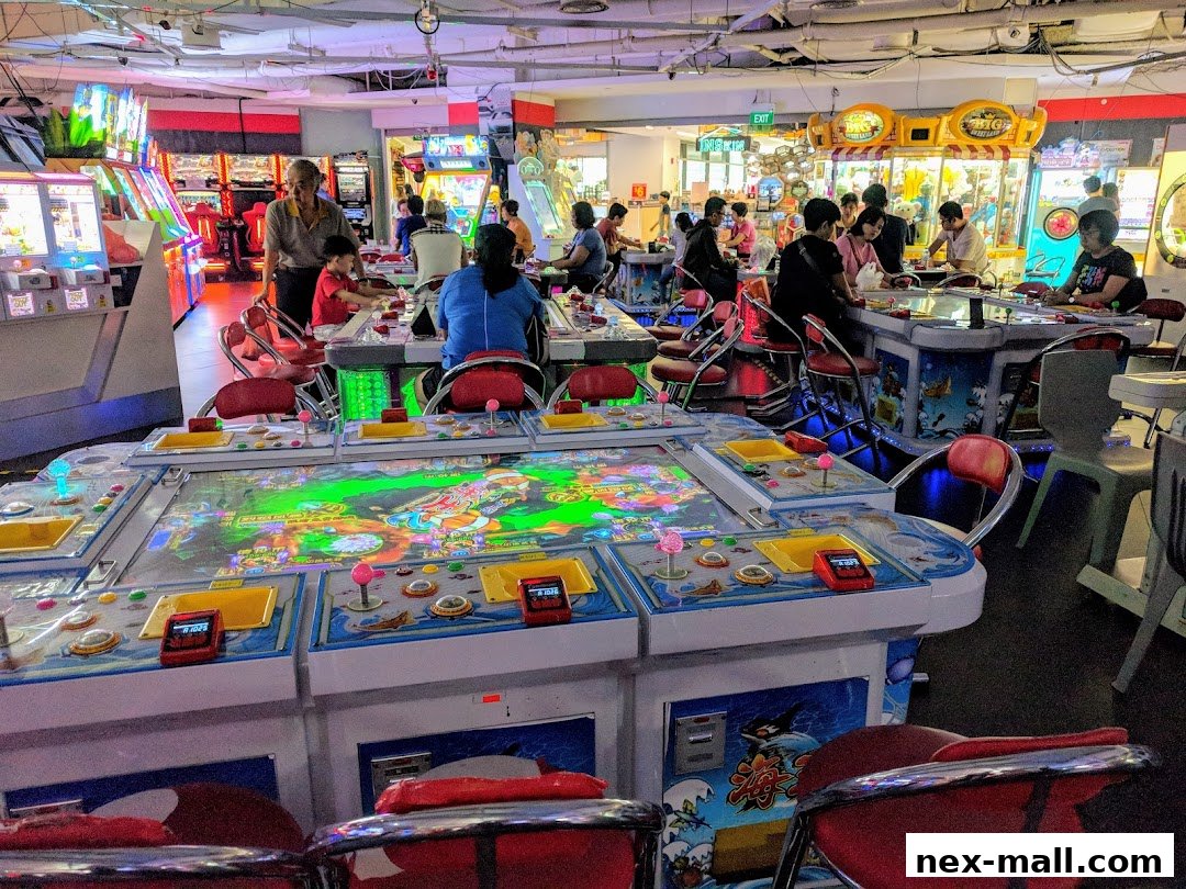 People playing arcade games at Virtualand - NEX, with colorful machines and seating.