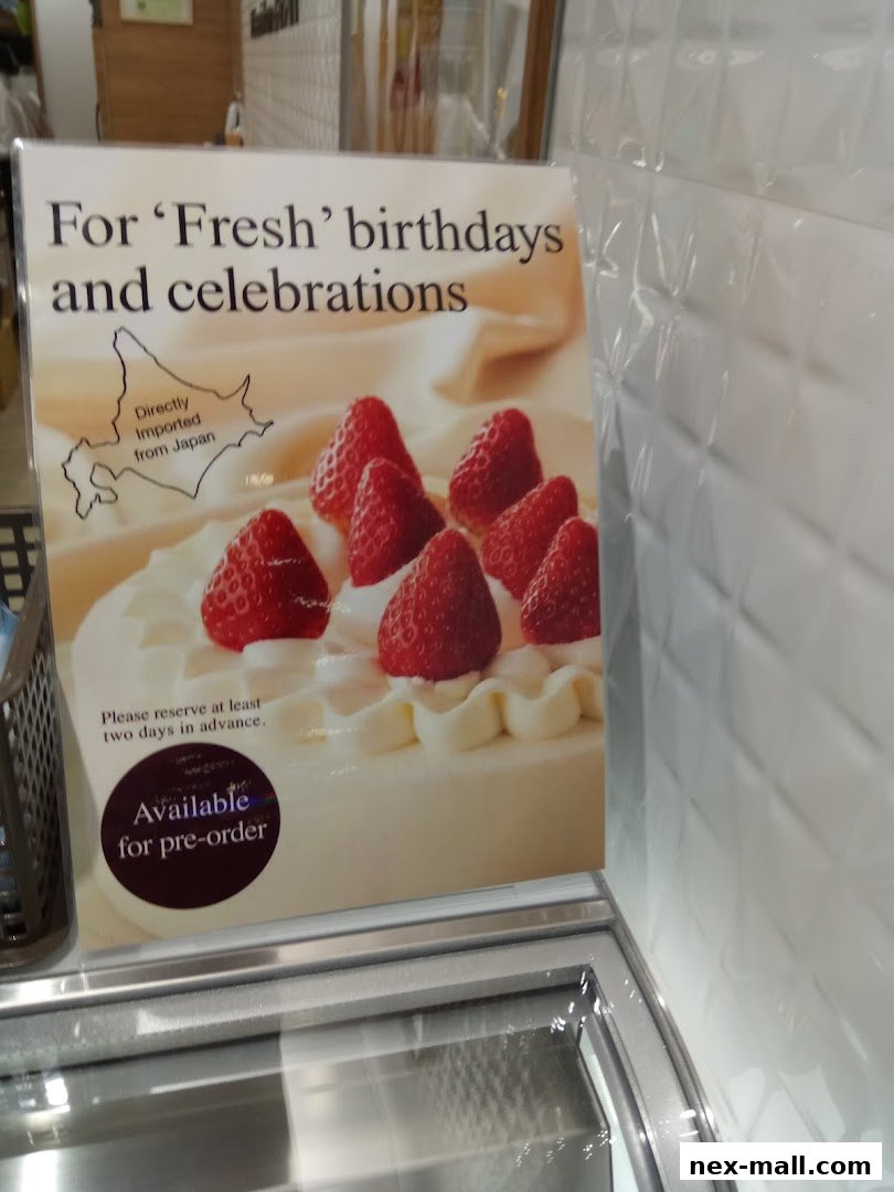 A sign advertising fresh, imported Japanese strawberry cakes available for pre-order.