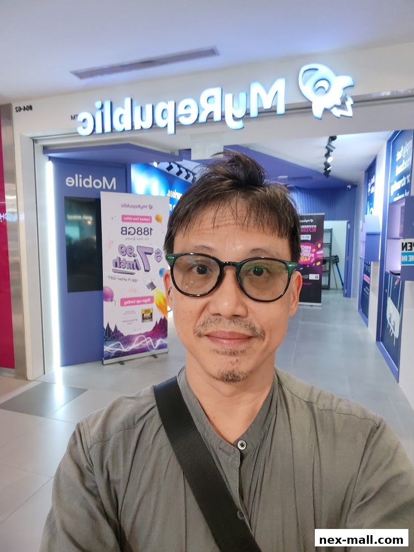 A man stands in front of the MyRepublic Store entrance, showcasing the shop's branding.