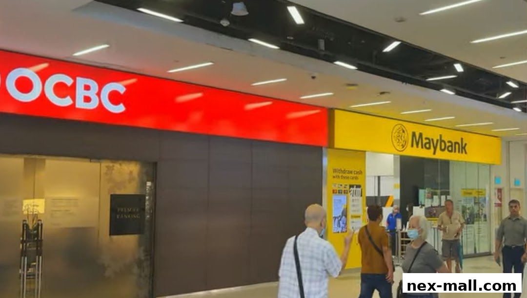 The exterior of OCBC Bank and Maybank branches in a shopping mall.
