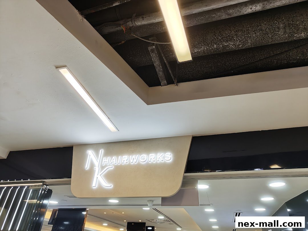 The illuminated sign for NK Hairworks is visible above the shop entrance.