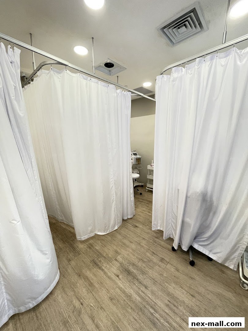 Interior view of a Kskin Korean Express Facial salon with white privacy curtains.